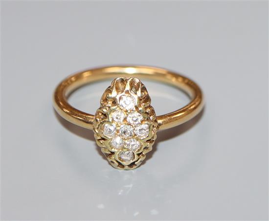 An early 20th century yellow metal and lozenge shaped diamond cluster ring, size M.